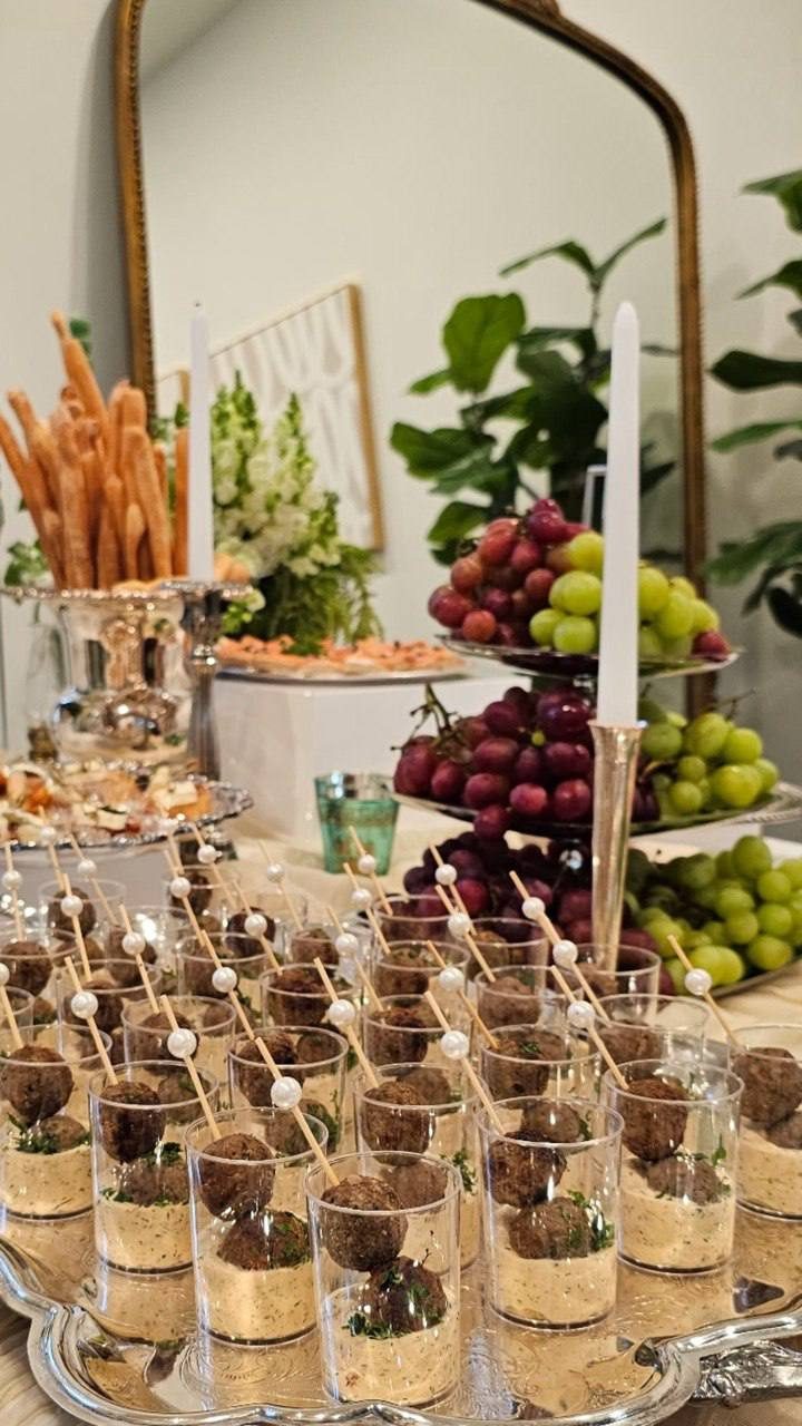 Chocolate dessert cups with gold crumb beside grapes and candlelight
